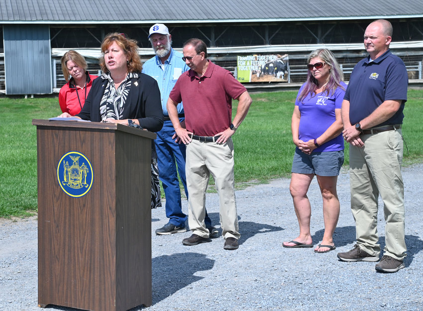 Assemblywoman Marianne Buttenschon, D-119, Marcy, state Sen. Joseph A. Griffo, R-47, Rome, are joined by several local farmers during a press conference discussing a proposed reduction in the farmworker overtime threshold during a press conference on Thursday at DiNitto&rsquo;s Farm on Benton Road in Marcy on Thursday.