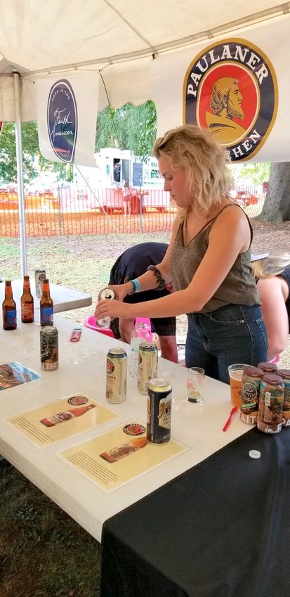 Craft Brand Manager Chelsee Roach of McCraith Beverage sets out a number of beers for tasting at the 25th annual Madison County Hop Fest.