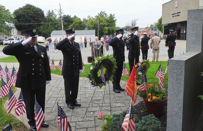 Members of the Oneida Fire Department and Oneida Police Department lay the wreaths and salute as part of the city's 9/11 Remembrance Ceremony, Sunday, Sept. 11, 2022.