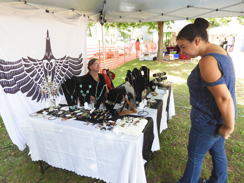 Lisa Fish, left, a resident of Oneida and owner of Magpie Mercantile, sells her handmade jewelry at the 58th Annual Madison County Craft Festival in Oneida, on Sept. 10, 2022.
