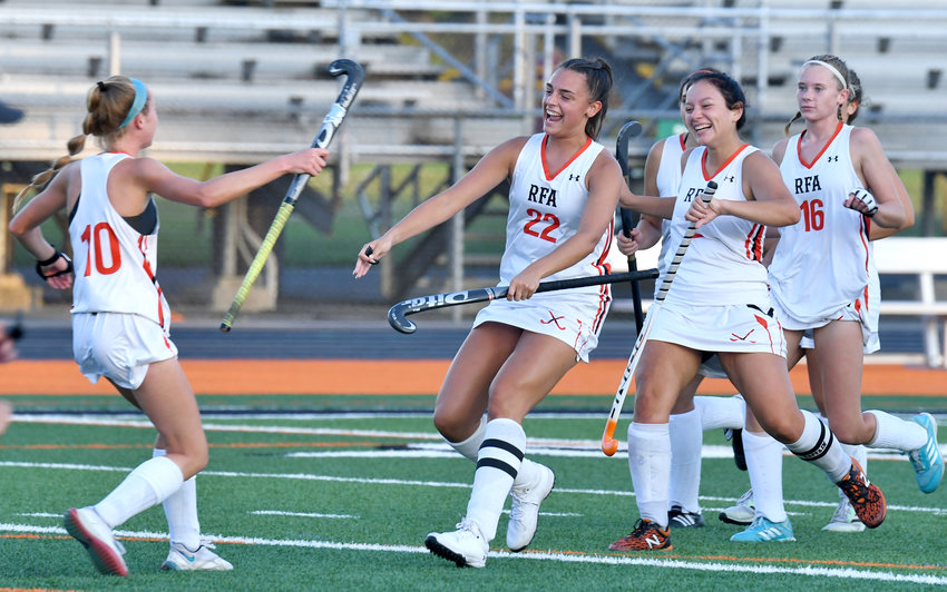 Isibeal McMahon, left, runs to celebrate the goal she scored on a penalty shot with Rome Free Academy teammates Drew Kopek (22), Alyce Frost and her twin sister Fiona McMahon (16) Wednesday night at RFA Stadium in a Tri-Valley League game against Camden. RFA won 5-0.