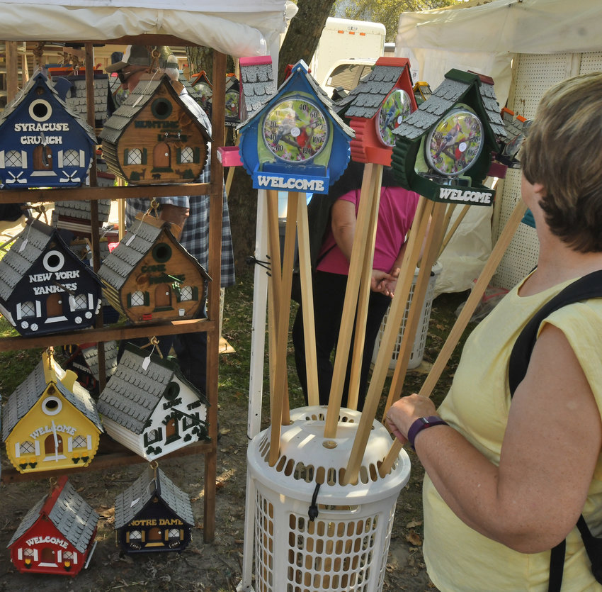 A customer looking at a selection of bird houses for sale at a previous Remsen Barn Festival of the Arts.