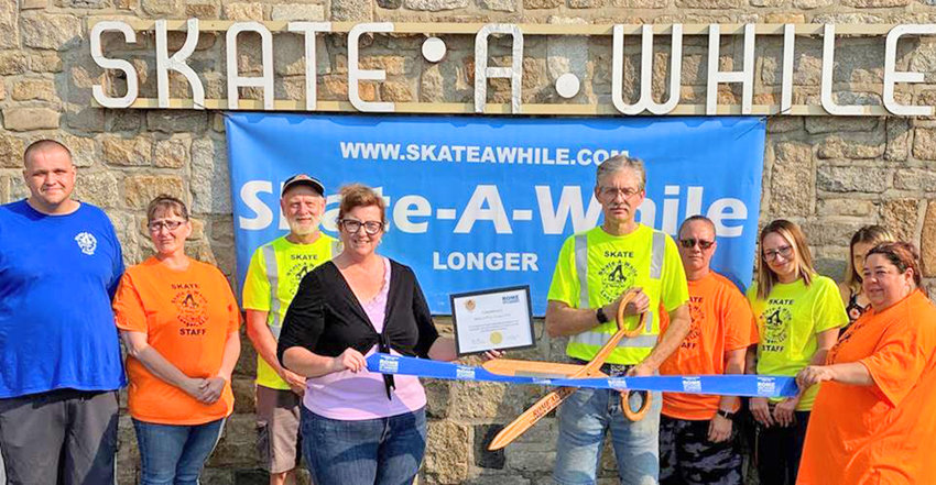 Skate-A-While Longer, LLC, 220 Ridge St., just celebrated its official ribbon cutting. Jamie Irwin, Rome Area Chamber of Commerce Membership Committee member, center, presented the congratulatory certificate to Russell Brookins, owner, shown cutting the ceremonial ribbon. Skate-A-While Longer staff members were on hand to join in on the celebration. From left: Austin Redner, Wendy Redner, Lee Hamann, Supervisor Cheri Ott, Elizabeth Buchanan, Allyson Hallday, and Jeanette Kelly.