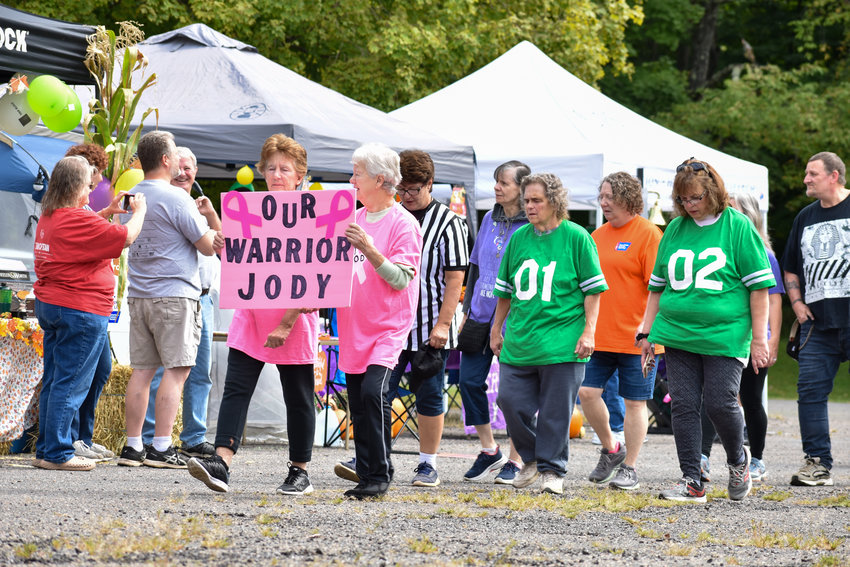 Walkers carried signs and wore customized shirts to send a message about their relationship with cancer.