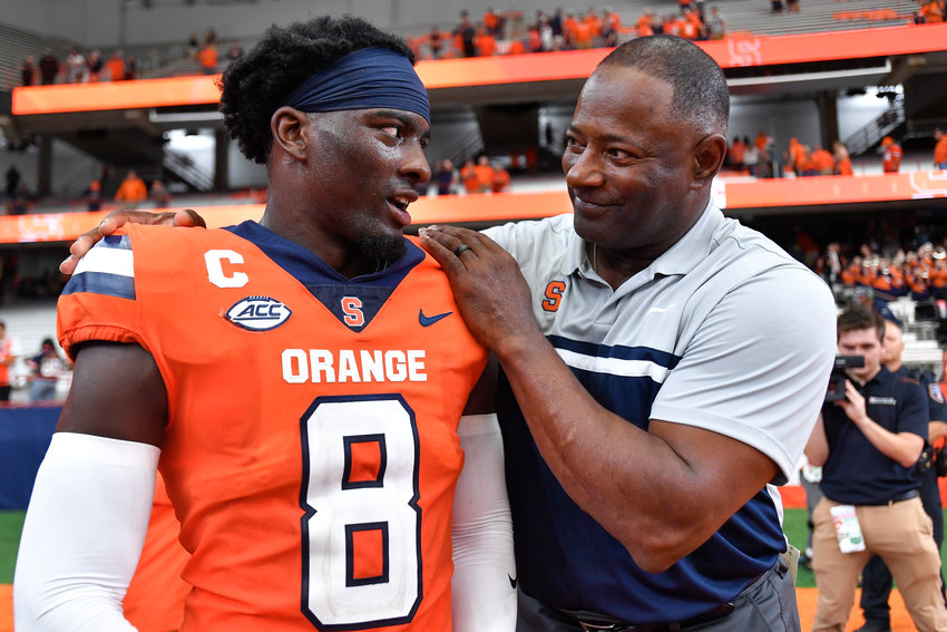 Syracuse head coach Dino Babers, right, celebrates with defensive back Garrett Williams after defeating Purdue on Saturday afternoon in a non-league game in Syracuse. Syracuse won 32-29.