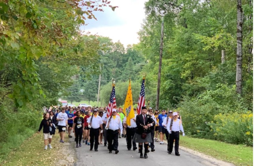 Participants and spectators at Connor&rsquo;s Way Run/Walk process to the start line lead by an Irish bagpiper and a Color Guard consisting of members of the New Hartford American Legion, Chapter 490 Order of the Purple Heart and the Vietnam Veterans Chapter 944 on Sunday, Sept. 18.