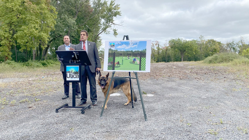 Utica Mayor Robert Palmieri, right, with his dog, Bear, and the city&rsquo;s Sixth District Councilor Joseph Betrus, discuss the future dog park to be located where they are standing at T.R. Proctor Park.