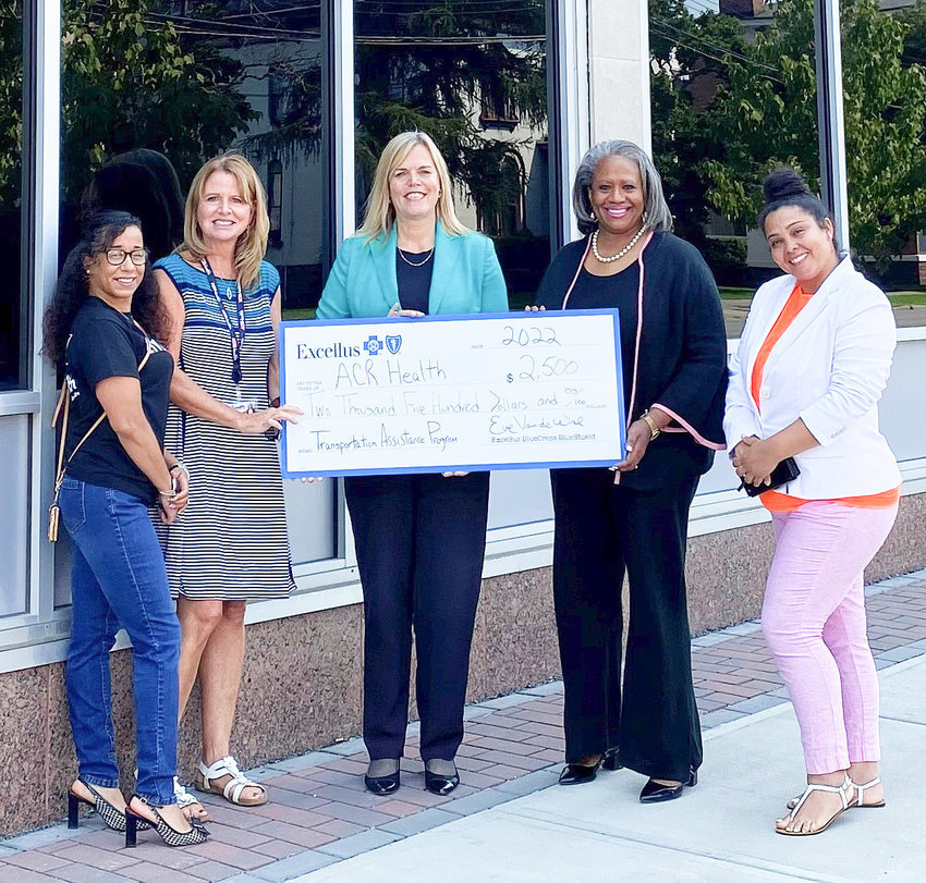 ACR Health Women&rsquo;s Linkage Specialist Alysia Johnson, left, Director of Development and Community Engagement Mary Beth Anderson, Excellus BCBS Regional President Eve Van de Wal, ACR Health Executive Director Lisa D. Alford and ACR Health Prevention CJI Supervisor Wendy Grullon gather together for a check presentation.
