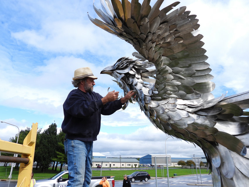 Sculptor James &ldquo;Jay&rdquo; Seaman makes some final adjustments to his work,  &ldquo;The Phoenix,&rdquo; as the artwork is installed in the green at the Hangar Road roundabout on Route 825 in the Griffiss Business &amp; Technology Park on Wednesday. The work adds to a host of works currently on display throughout the park and its art trail.