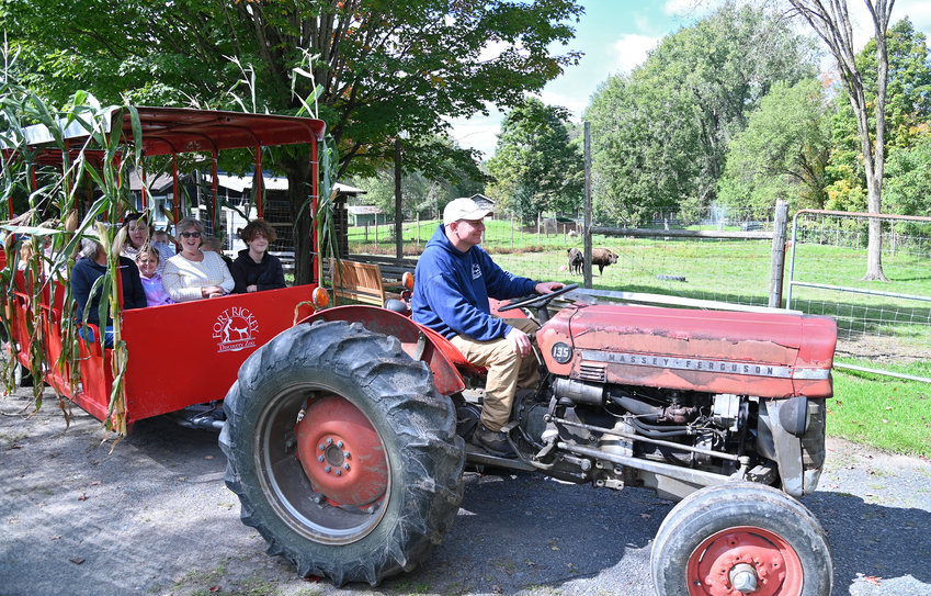 Fort Rickey Discovery Zoo owner Chris Stedman operates the antique tractor pull ride Saturday afternoon during the Rome zoo&rsquo;s Fall Fun Days. The tractor ride and other fun fall activities continue through the end of October.