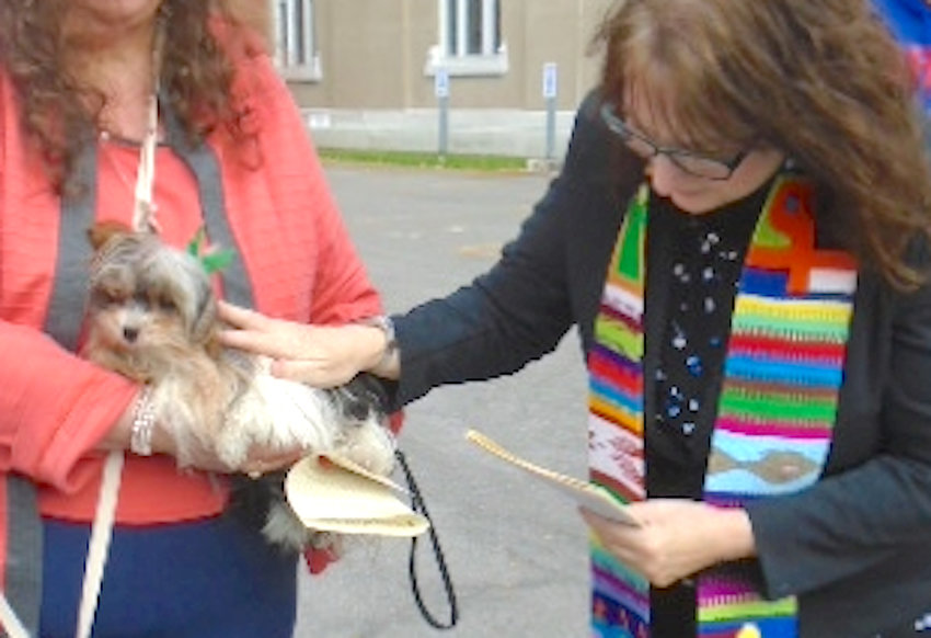 Rev. Edwina Landry offers a prayer to a pet from the community in last season&rsquo;s &ldquo;Blessing of the Animals.&rdquo;