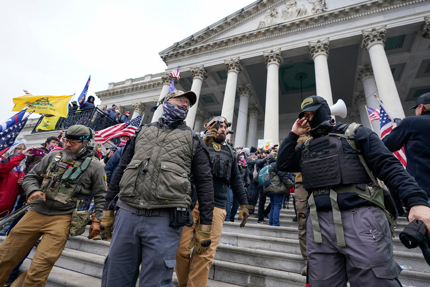 Members of the Oath Keepers stand on the East Front of the U.S. Capitol on Jan. 6, 2021, in Washington. Federal prosecutors on Monday, Oct. 3, will lay out their case against the founder of the Oath Keepers' extremist group and four associates charged in the most serious case to reach trial yet in the Jan. 6, 2021 U.S. Capitol attack.