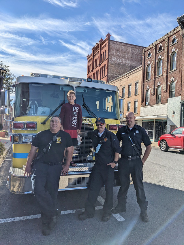 Eight-year-old Dominic Diaz was happy to pose for a photo with members of the Oneida Fire Department who helped deliver a brand new bed for him that was built and donated by Sleep in Heavenly Peace&rsquo;s Syracuse chapter.
