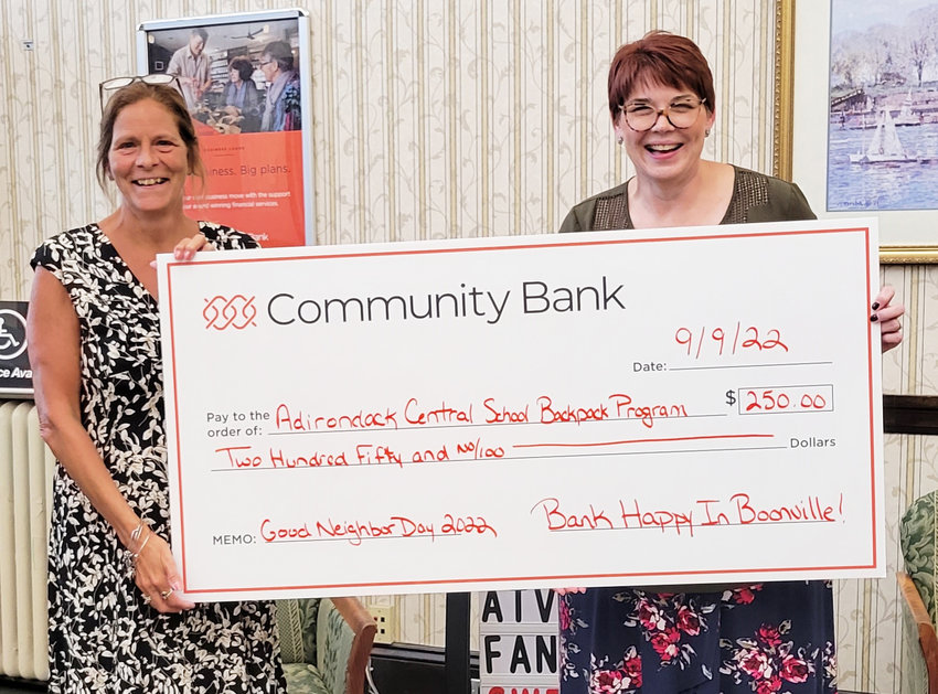 Lindsay Cavanaugh (left), retail services officer at Community Bank&rsquo;s Boonville branch, and Cynthia Shanks, branch manager, showing the Good Neighbor Day donation of $250 to the Adirondack Central School Backpack Program.