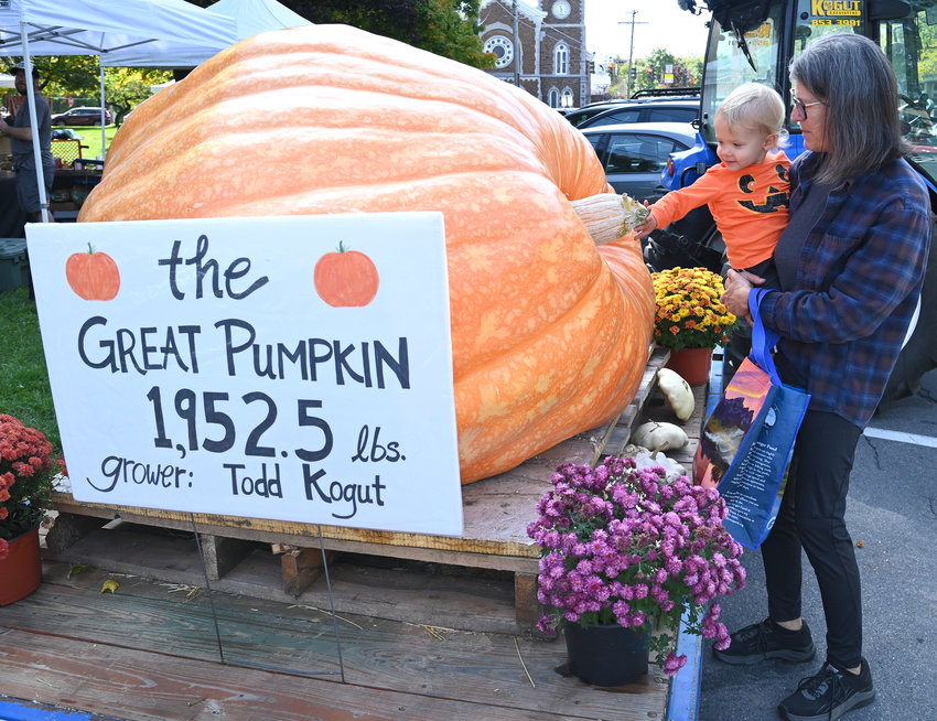 Corbin Isenberg, 2, from Holland Patent, checks out the Great Pumpkin on display at the Clinton Farmers Market on Thursday. Corbin was with his grandma, Nedra Isenberg, from Deerfield. Apparently, Corbin loves pumpkins, so the grandma made the special trip to Clinton to visit the Great Pumpkin.
