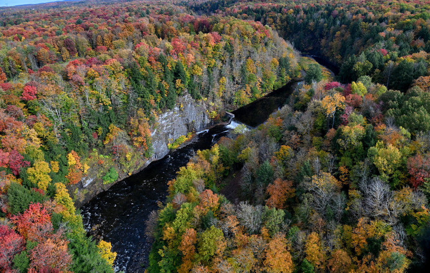 A colorful carpet of peak foliage abounds in Annsville near the Kessinger Dam in this aerial view taken by helicopter on Wednesday, Oct. 12.  The dam, off of Boyd Road, impounds water from the East Branch of Fish Creek, which originates in Lewis County where the Sixmile and Sevenmile creeks converge, about 10 miles west of Lyons Falls. The Kessinger Dam, completed in 1909, provides part of the water supply for the city of Rome as impounded water is diverted through a mile-long tunnel and a 7-mile pipeline to city reservoirs. The gorge, whose walls extend upwards of 70 feet, was carved out during the last Ice Age, according to geologists. According to the I LOVE NY fall foliage report, most of the state will be at peak conditions this weekend.