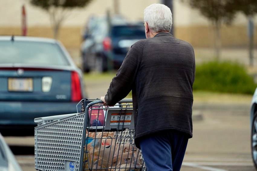 An older customer pushes his Kroger shopping cart laden with purchases in Jackson, Miss., Wednesday, Oct. 12, 2022. Millions of Social Security recipients will soon learn just how high a boost they&sbquo;&Auml;&ocirc;ll get in their benefits next year. The increase will be announced Thursday morning.