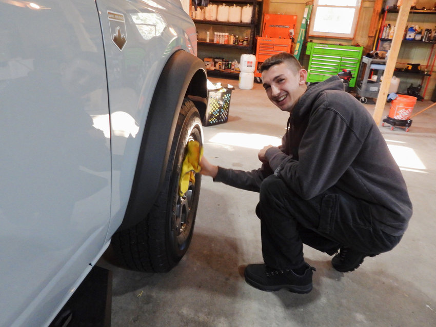 Business owner Jeff Pacini works on the final touches for a vehicle that came into his Westmoreland shop.