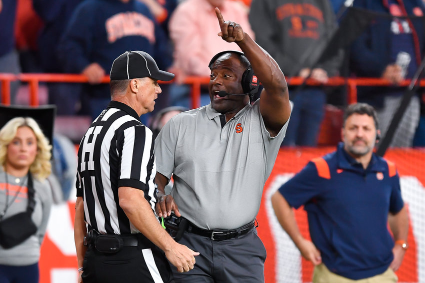 Syracuse coach Dino Babers, right, talks to head linesman John Hoffman during the the team&rsquo;s game against Virginia on Sept. 23 in Syracuse.