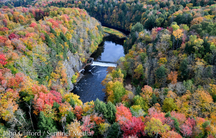 A colorful carpet of peak foliage abounds in Annsville near the Kessinger Dam in this aerial view taken by helicopter on Wednesday. The dam, off of Boyd Road, impounds water from the East Branch of Fish Creek, which originates in Lewis County where the Sixmile and Sevenmile creeks converge, about 10 miles west of Lyons Falls. The Kessinger Dam, completed in 1909, provides part of the water supply for the city of Rome as impounded water is diverted through a mile-long tunnel and a 7-mile pipeline to city reservoirs. The gorge, whose walls extend upwards of 70 feet, was carved out during the last Ice Age, according to geologists.