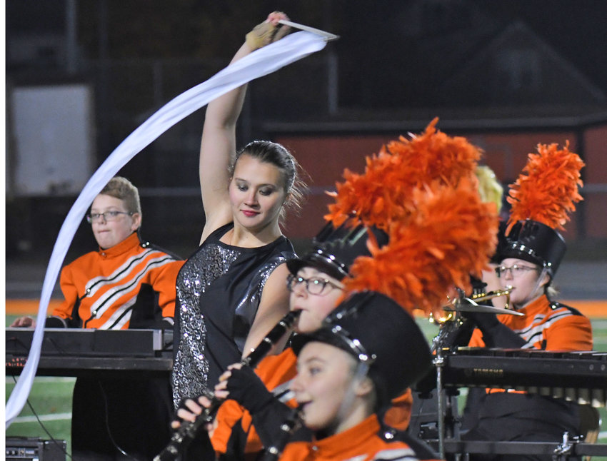Colorguard leader Karabrie Wiggins, center, twirls her ribbon as the Rome Free Academy Marching Band performs its halftime show Oct. 21 at RFA Stadium. The band will be one of three area marching bands competing Sunday in the New York State Field Marching Band Conference 2022 Championships at the JMA Dome in Syracuse. See related stories, page 7.