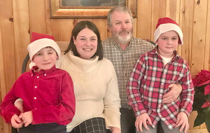 James Cooley, Dawn Cooley, Michael Cooley, and Thomas Cooley celebrating Christmas with family.