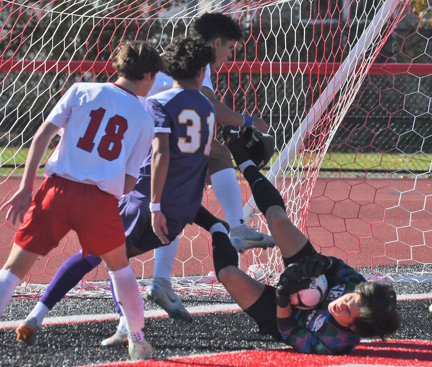 CBA goalie Finn Wheeler makes a save in front of a New Hartford player in the first half of Saturday afternoon's Section III Class A final at Chittenango High School. Looking on is New Hartford's Noah Patenza (18) and CBA's Santiago Betancourt-Trompa (31).