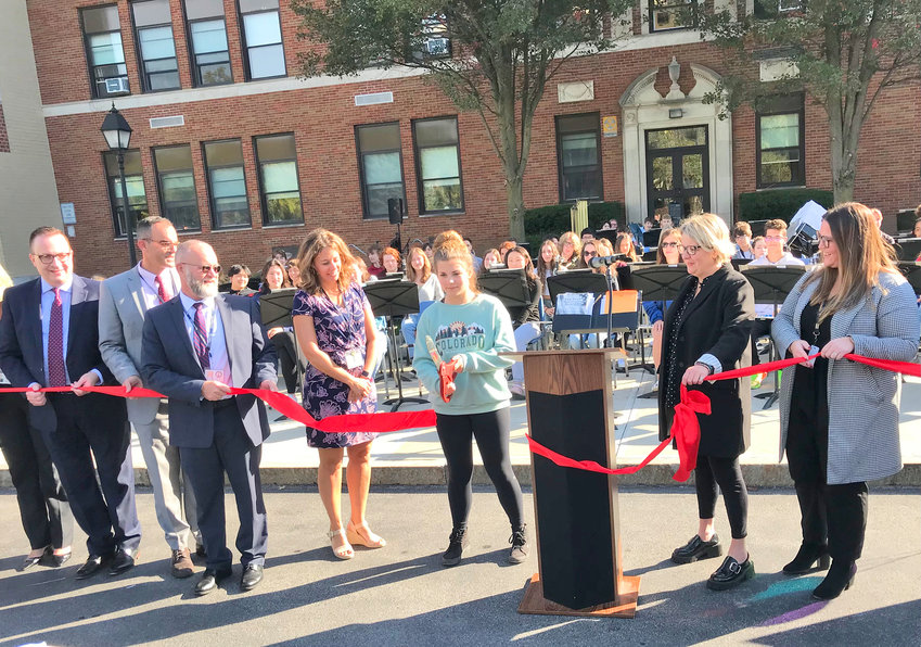 New Hartford Senior High School junior Grace Hollenbeck, center, joins district and Connected Community Schools officials at a recent ribbon-cutting ceremony. The district has launched a strategic plan initiative, gaining valuable insight from stakeholders in a districtwide survey.