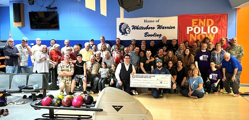 Participants in the 2022 Pin Down Polio fundraiser at Vista Lanes in Yorkville pause for a photo at the event&rsquo;s check presentation ceremony.