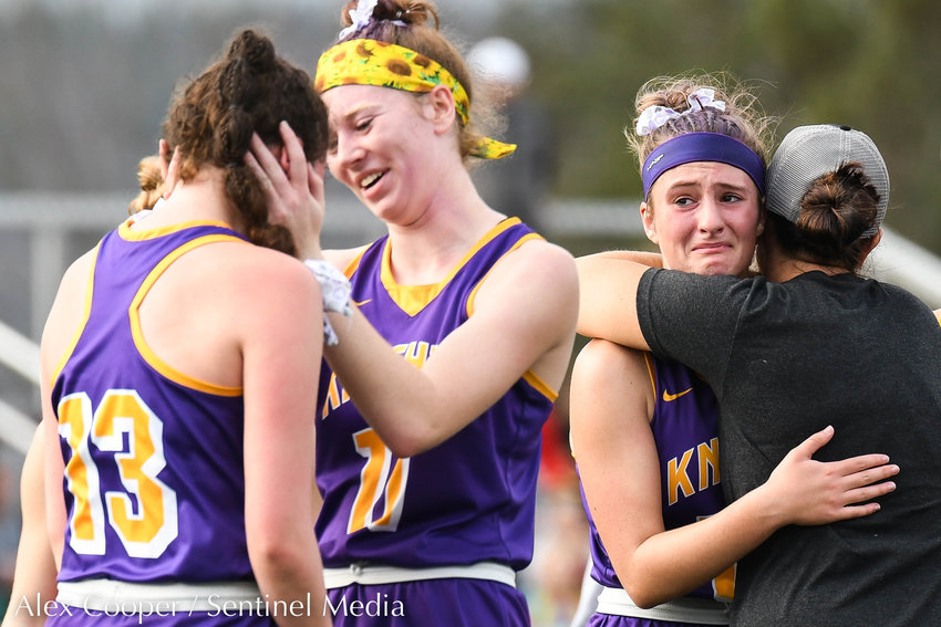 From left, Holland Patent player Abby Draper comforts teammate Izzy Stalker (13) as head coach Renee Morrison comforts player Zoe Kelly after losing the Class B field hockey state regional to Vestal 2-1 on Saturday at Sidney High School.