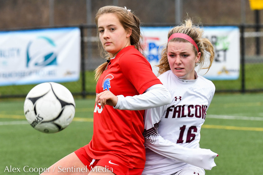 From left, New Hartford player Anna Rayhill attempts to settle a loose ball with Albertus Magnus player Stephanie Koblish (16) during the Class A state final on Sunday at Tompkins-Cortland Community College. The Spartans lost 3-1.
