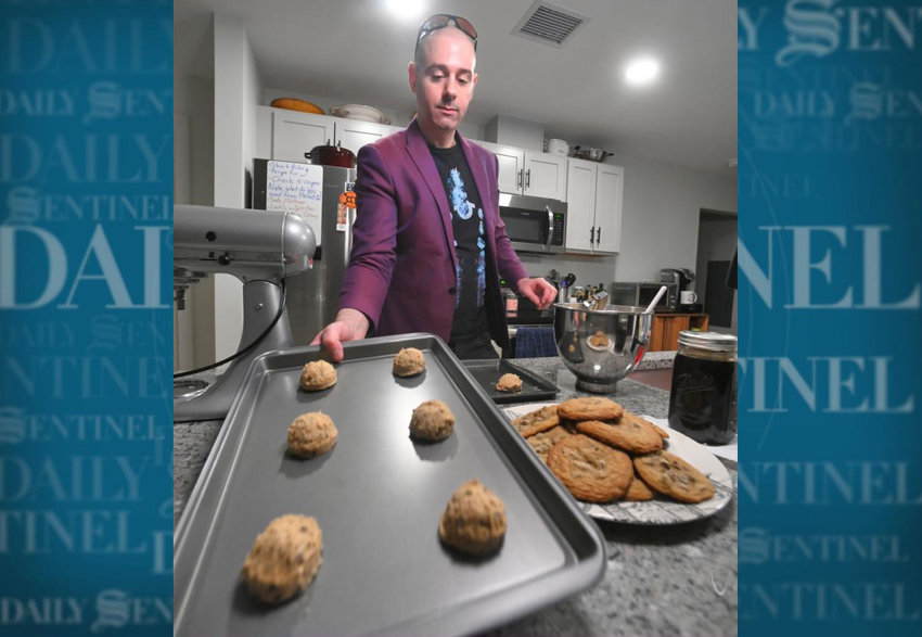James Daino picks up a cookie sheet of his cookies to bake Nov. 9 in his Rome kitchen. Daino is currently vying for the Top 10 in Bake from Scratch magazine's Greatest Baker competition for 2022.