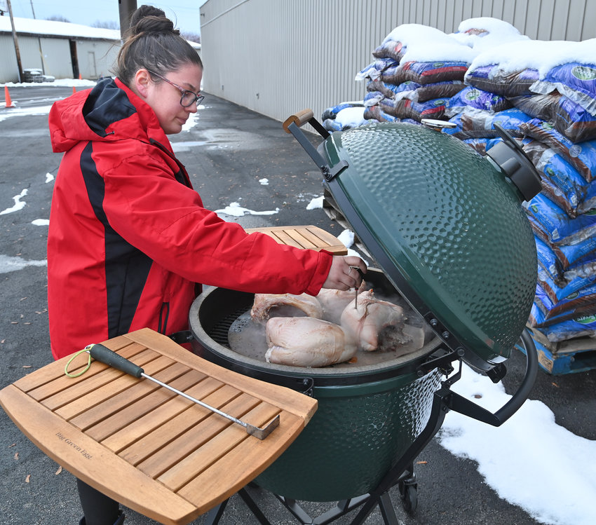 HAPPY THANKSGRILLING! &mdash; Alex Bauer, a supervisor at ACE Hardware, 115 Black River Blvd. South, checks some turkey breasts cooking in the Big Green Egg smoker at the store Friday, Nov. 18. The store and its staff will welcome customers to celebrate Thanksgrilling Saturday, Nov. 19 from 11 a.m. to 2 p.m. During the event, turkey sliders will be available along with Apple Cinnamon cups and ACE Famous Popcorn featuring different rubs.