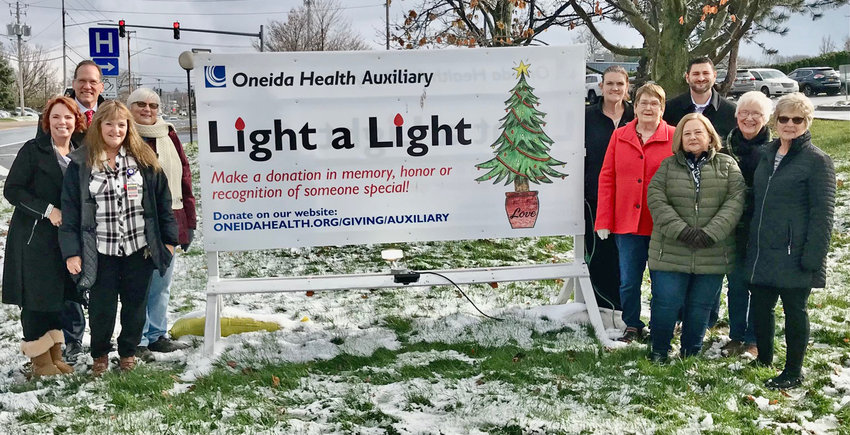 Oneida Health Auxiliary members pose with administrators from the hospital and its Extended Care Facility Wednesday in Oneida to announce the return of the annual Light a Light fundraiser.