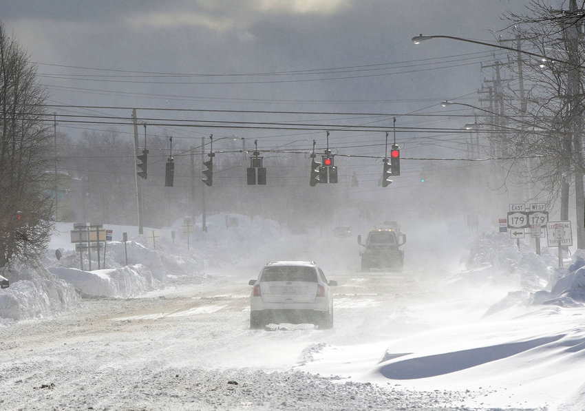 Cars drive through blowing, drifting snow on McKinley Parkway in Hamburg in Erie County, N.Y., Sunday, Nov. 20, 2022.