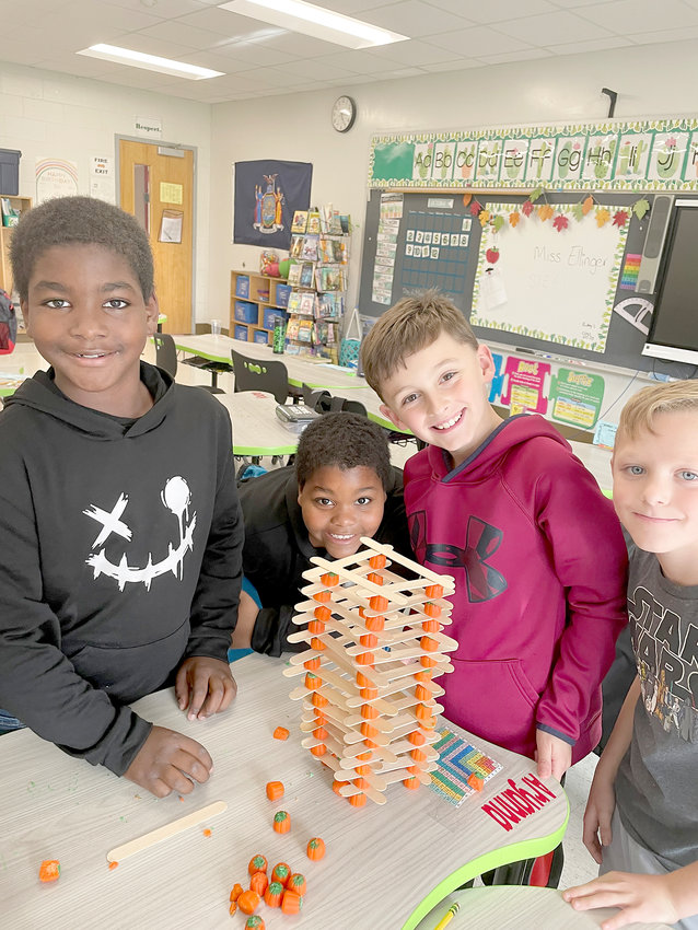 Herkimer Elementary School STEM Club 3 members, from left, Quamar Davis, Quameer Davis, Dillon Denton and Alek Bailey-LaVeck, participate in a challenge using candy corn pumpkins and Popsicle sticks to build towers.