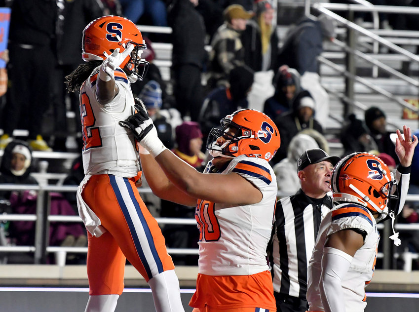 Syracuse wide receiver Damien Alford, left, and Matthew Bergeron (60) celbrate Alford's go-ahead touchdown during the second half against Boston College on Saturday night in Boston. The Orange won 32-23.