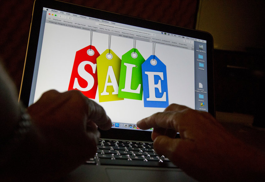 In this Dec. 12, 2016, photo, a person searches the internet for sales, in Miami. Days after flocking to stores on Black Friday, consumers are turning online for Cyber Monday to score more discounts on gifts and other items that have ballooned in price because of high inflation. Adobe Analytics, which tracks transactions for top online retailers, forecasts Cyber Monday will remain the year&rsquo;s biggest online shopping day and rake in up to $11.6 billion in sales.