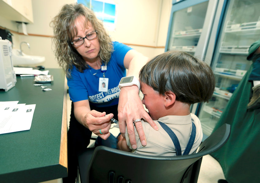 A registered nurse and immunization outreach coordinator with the Knox County Health Department, administers a vaccination to a kid at the facility in Mount Vernon, Ohio, in 2019. In a report issued on Nov. 23, the World Health Organization and the U.S. Centers for Disease Control and Prevention say measles immunization has dropped significantly since the coronavirus pandemic began, resulting in a record high of nearly 40 million children missing a vaccine dose last year.