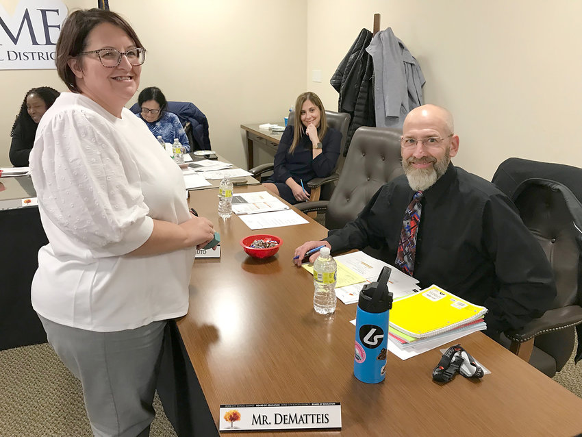 Rome City School District Personnel Assistant Shelly Schultheis, left, welcomes new Board of Education member Jeff DeMatteis at the board&rsquo;s Nov. 28 meeting.