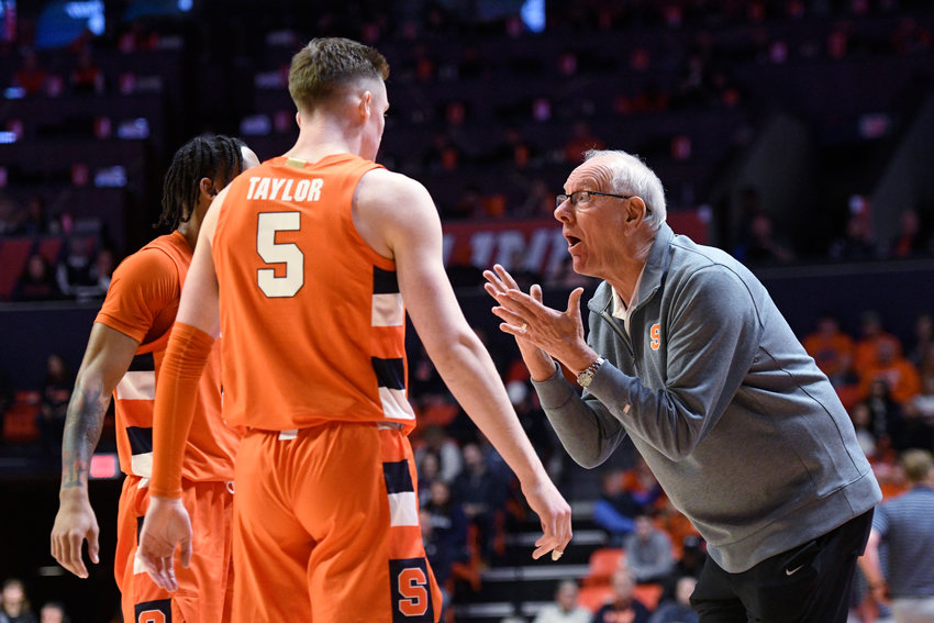 Syracuse coach Jim Boeheim, right, talks with Justin Taylor (5) and a teammate during the first half of Tuesday night&rsquo;s game against Illinois in Champaign, Ill. The Orange lost 73-44.