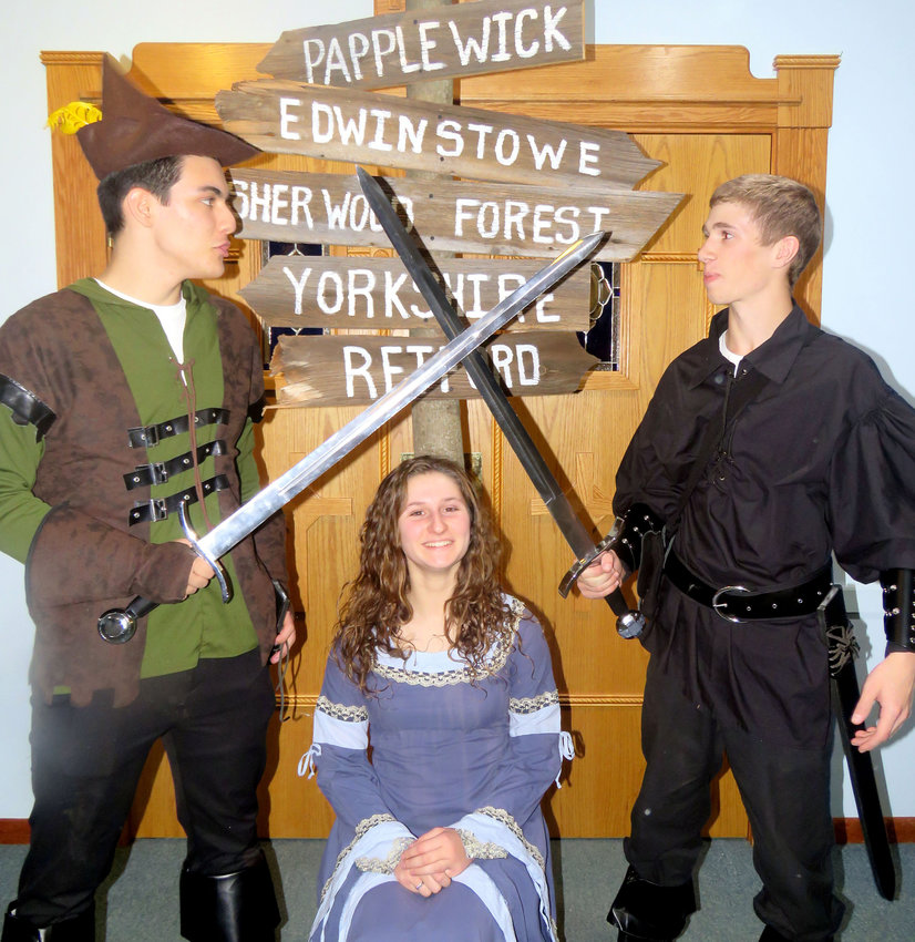 Luke Collins, left, as Robin Hood; Catherine Lohr, center, as Maid Marian and Mason Netzband as the Sheriff of Nottingham invite the public to their performance of &lsquo;Robin Hood&rsquo; at 7 p.m. Dec. 9 and 10 and 2 p.m. Dec. 11 at Holy Cross Academy in Oneida.