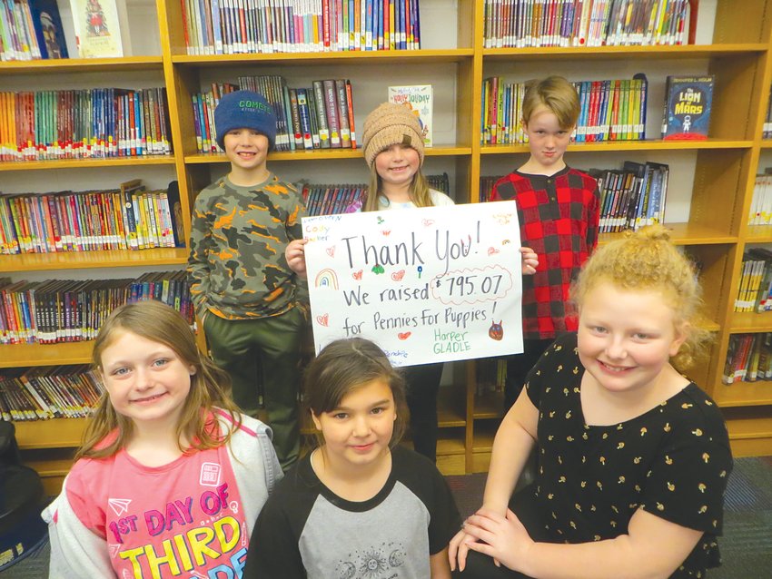 McConnellsville Elementary School students including, front row, from left, Harper Gladle, Penelope Freywald and Lillian Dote and back row, from left, Cody Barber, Leila Barnes and Wyatt O&rsquo;Hern, along with classmate Cora Lappin, recently raised $795.07 in a Pennies for Puppies coin drive for pets in need.