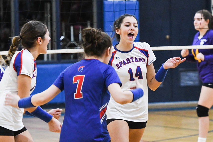 New Hartford volleyball players Keegan Matthews (14), Micaela Magno (7) and teammates celebrate after scoring a point during the match against Holland Patent on Monday in New Hartford. The Spartans won in three straight sets. Matthews had five kills and Magno had nine digs and a pair of aces in the win.
