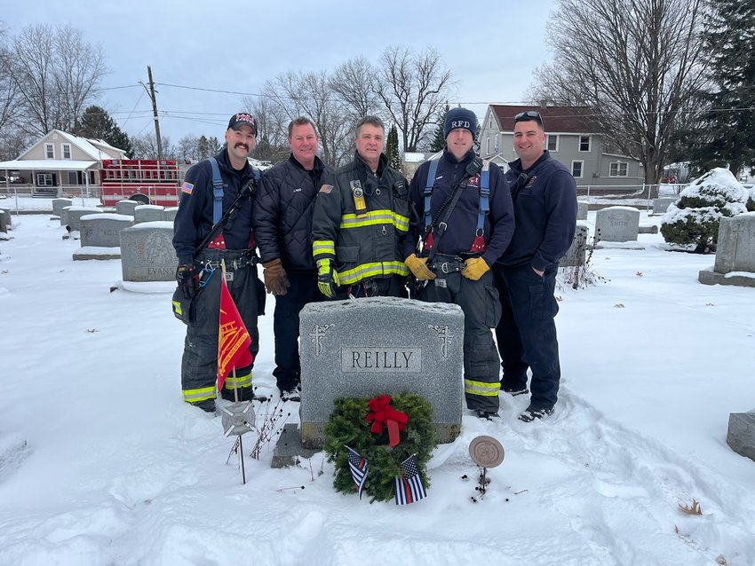 Rome Firefighter Philip C. Urtz, Firefighter John J. Reid, Captain Daniel F. Gifford, Lt. Cody J. Thieme and Firefighter Alexander M. Brement place a wreath in honor Rome Fire Chief Bill Reilly, an Air Force veteran, at St. Peter&rsquo;s Cemetery.
