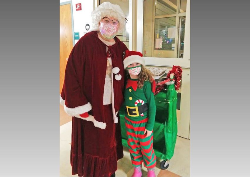 Mrs. Claus, left, and Pajama Express creator Julia Kervin invite the community to the free community light tour at 6:50 p.m. Dec. 21 starting at the Waterville Public Library and traveling throughout the village.