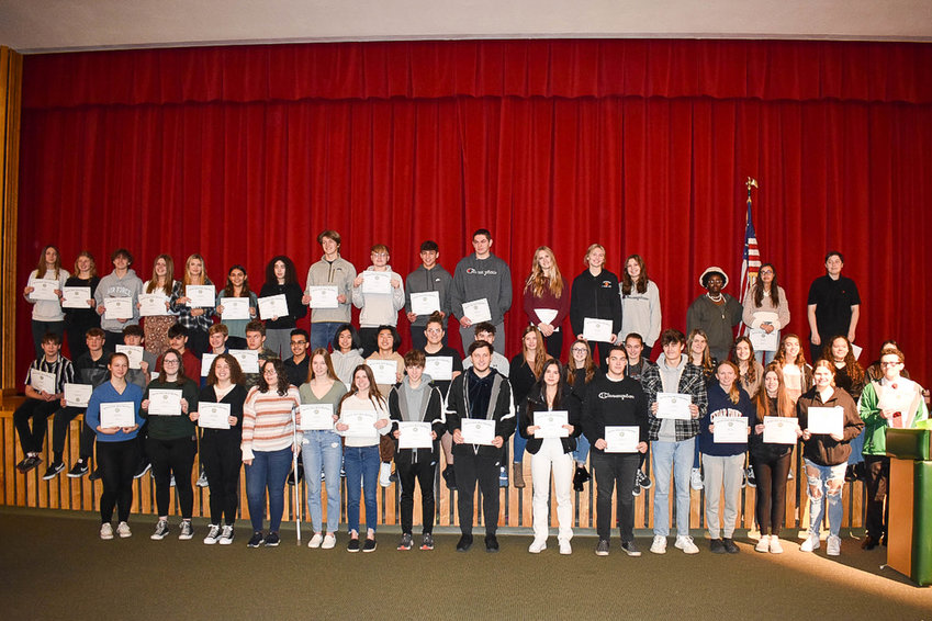 Herkimer Central School District students in grades 10-12 who won Academic H Awards pose Dec. 20 on stage following the ceremony.