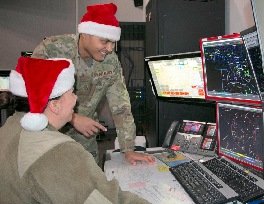 Master Sgt. Brian Burgess, standing, and Maj. Bonnie Bosworth of the New York Air National Guard&rsquo;s 224th Air Defense Squadron, train for Santa tracking operations on Dec. 16 at the Eastern Air Defense Sector in Rome. Part of the North American Aerospace Defense Command (NORAD), EADS is responsible for the air defense of the eastern U.S.