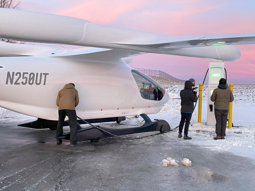 Individuals with Beta Technologies charge up their plane recently so it could be flown again to Saranac Lake, as part of test flights for the aircraft.