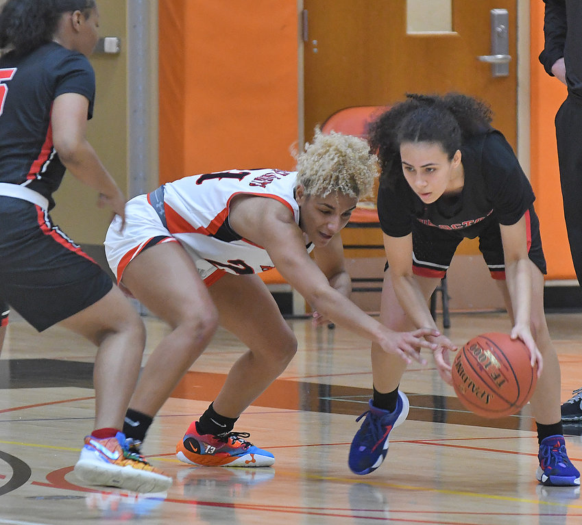 Rome Free Academy defender Amya McLeod goes for the steal against Thomas R. Proctor High&rsquo;s Lleneila Rodriguez in the first quarter at RFA Saturday. On the left is Proctor&rsquo;s Nyasiah Moore. McLeod scored 19 points in RFA&rsquo;s 66-34 win.